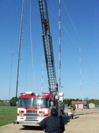 Fire Engine with ladder extended into the air.