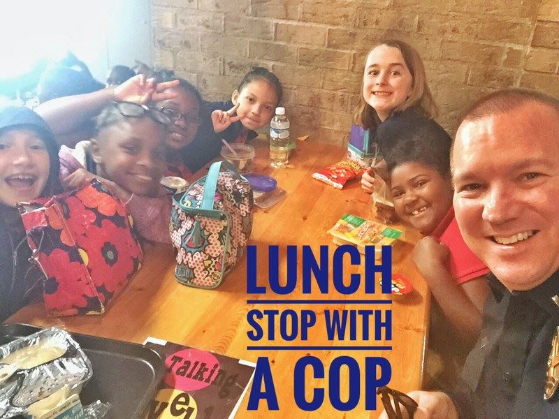 Police Officer having lunch with children for the Lunch Stop with a Cop program.