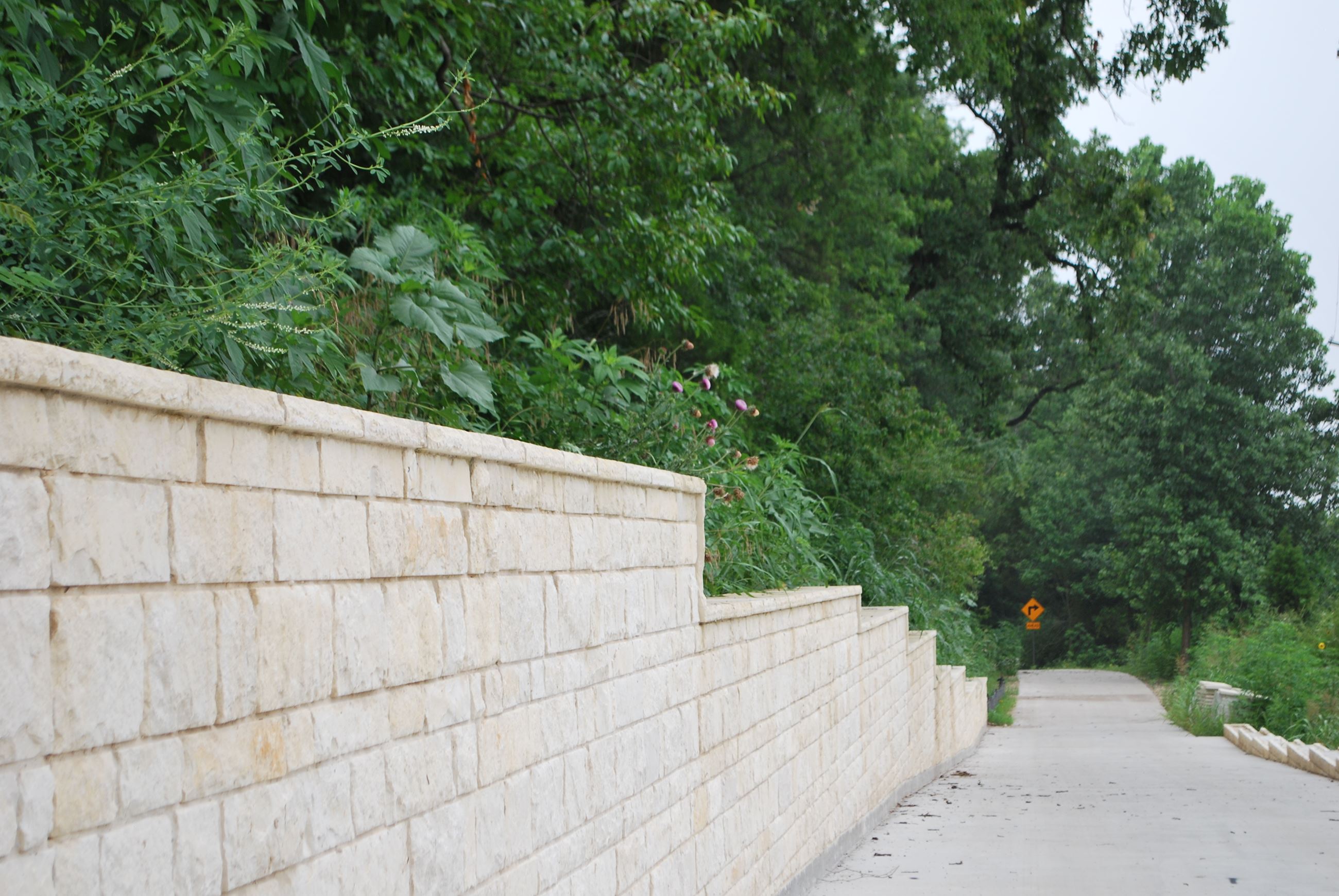 Granite wall along paved trail.